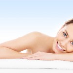A picture of a young woman resting her head on a towel over blue background